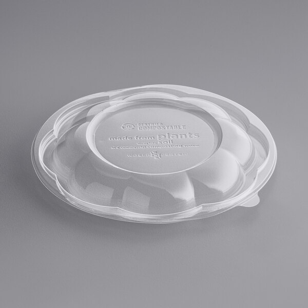 A clear World Centric plastic lid on a white plastic container.