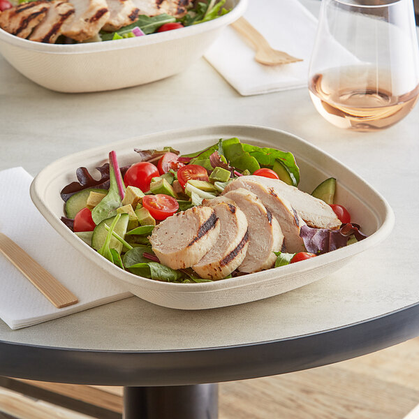 A salad in a World Centric compostable square fiber bowl with chicken and vegetables.