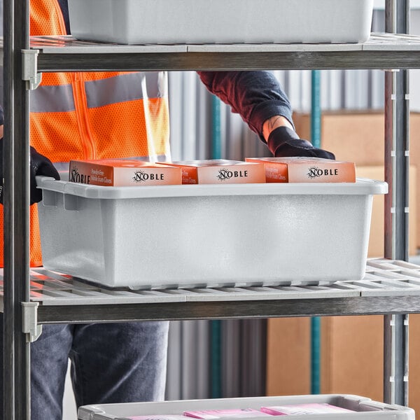 A gray polyethylene utility bin measuring 20 by 15 by 5 inches placed on a metal shelving unit.
