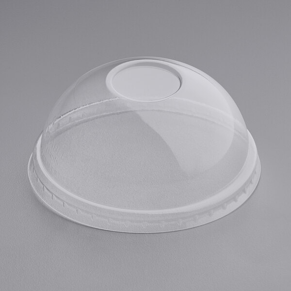 A World Centric clear plastic dome lid on a clear plastic container.