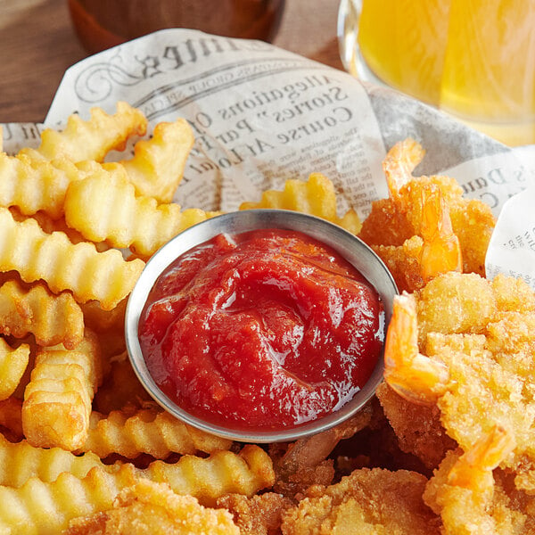 A white plate with a bowl of Heinz chili sauce and french fries.