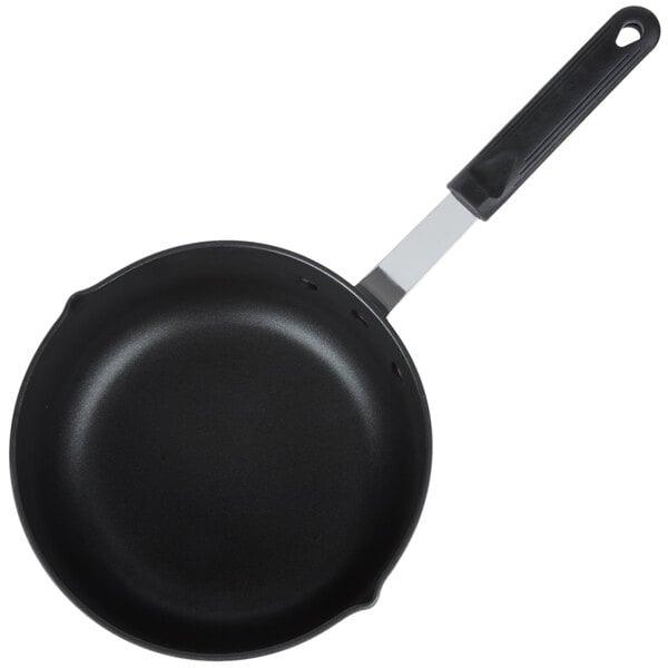 A black sauce pan with a handle.
