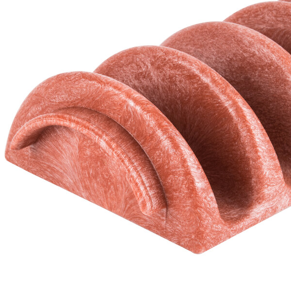 A stack of four red polyethylene taco servers shaped like shells.