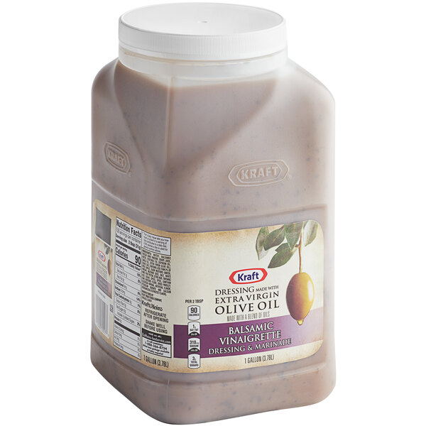 A plastic container of Kraft Signature Balsamic Vinaigrette Dressing with a white label.