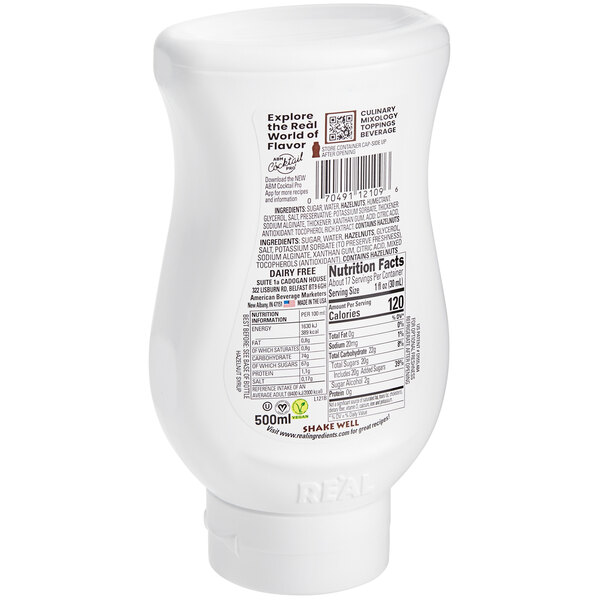 A white plastic bottle of Real Cream of Hazelnut Infused Syrup with black and red text.