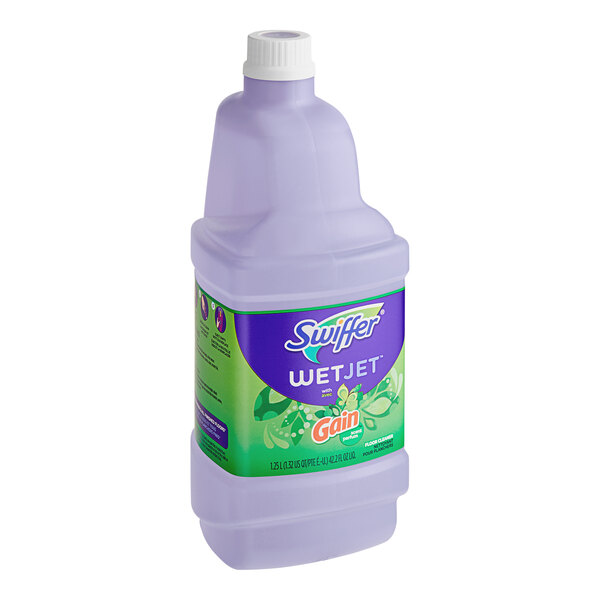 A close-up of a Swiffer WetJet Multi-Surface Cleaner Solution refill bottle with purple liquid inside.