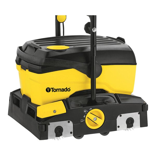 A black and yellow Tornado walk behind cylindrical floor scrubber with a handle.