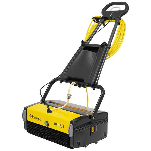 A yellow and black Tornado walk behind cylindrical floor scrubber with yellow wires.