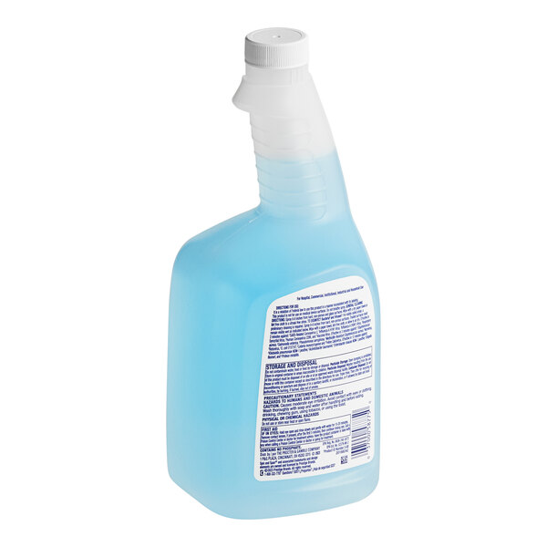 A close-up of a blue plastic bottle of Spic and Span glass cleaner with a white label and cap.