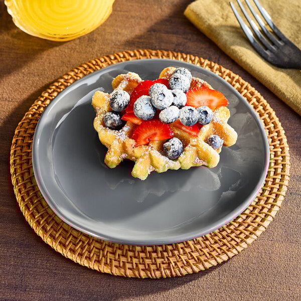 An American Metalcraft Crave Storm Coupe Melamine Plate with a waffle topped with strawberries and blueberries.