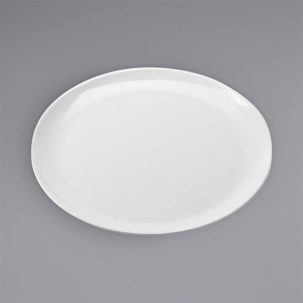 An American Metalcraft white melamine pizza plate with a round rim on a gray surface.