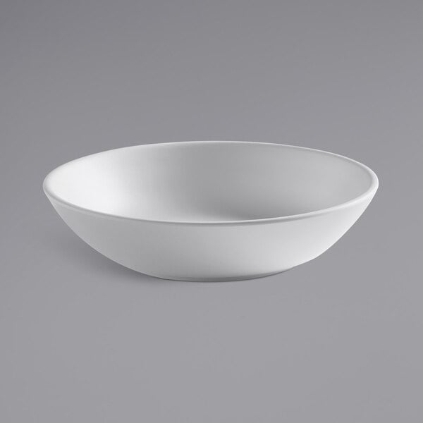 An American Metalcraft white matte melamine bowl on a gray surface.