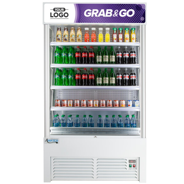 An Avantco white refrigerated air curtain merchandiser with a display of soda bottles.