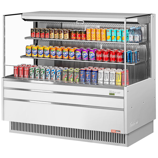 A white Turbo Air refrigerated curtain merchandiser filled with soda cans.