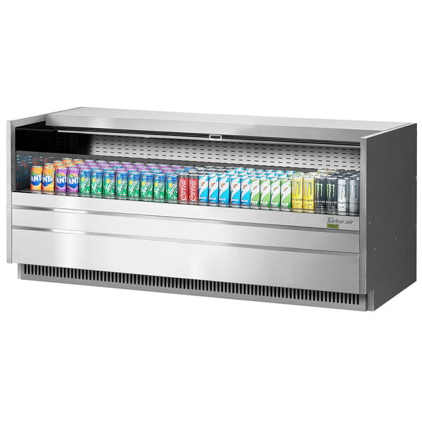 A Turbo Air stainless steel drop-in refrigerated display case with many cans of soda inside.