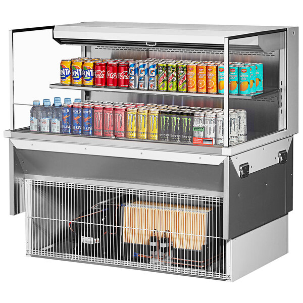 A Turbo Air drop-in refrigerated display case with drinks and cans on a shelf.