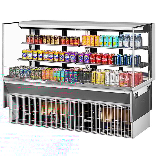 A Turbo Air white drop-in refrigerated display case with cans of soda on shelves.