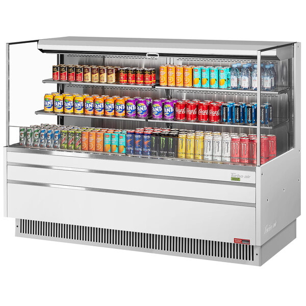 A white Turbo Air horizontal refrigerated display case with drinks and snacks on shelves.