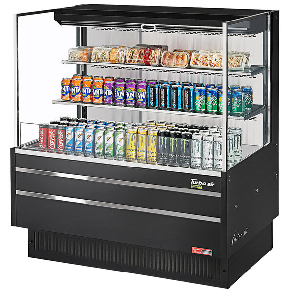 A black Turbo Air refrigerated open curtain merchandiser with drinks and beverages on shelves.