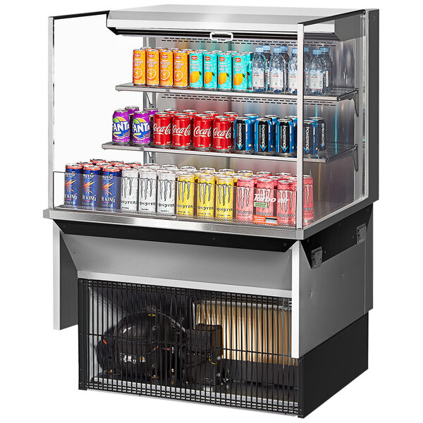 A Turbo Air stainless steel drop-in refrigerated display case with drinks and cans inside.