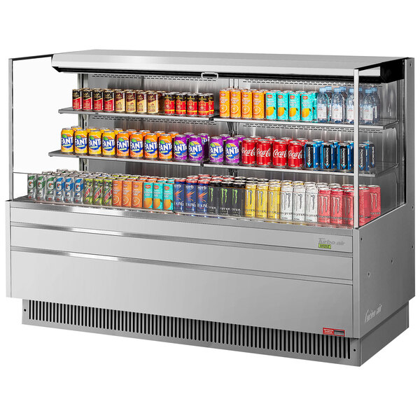 A Turbo Air stainless steel horizontal refrigerated display case with shelves of canned beverages.