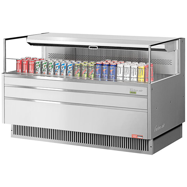 A Turbo Air stainless steel horizontal refrigerated curtain merchandiser with cans of soda inside.