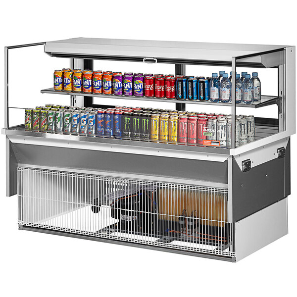 A Turbo Air white drop-in refrigerated display case with cans of soda and different flavored drinks.