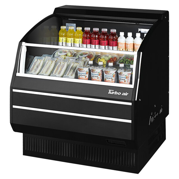 A black Turbo Air horizontal refrigerated open curtain merchandiser on a counter with food in it.