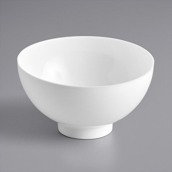 A white bowl sitting on a table.