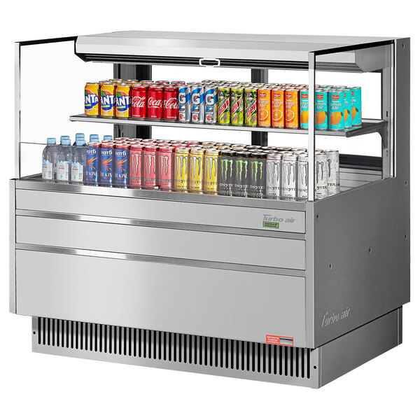 A Turbo Air horizontal refrigerated curtain merchandiser with drinks and cans on it.