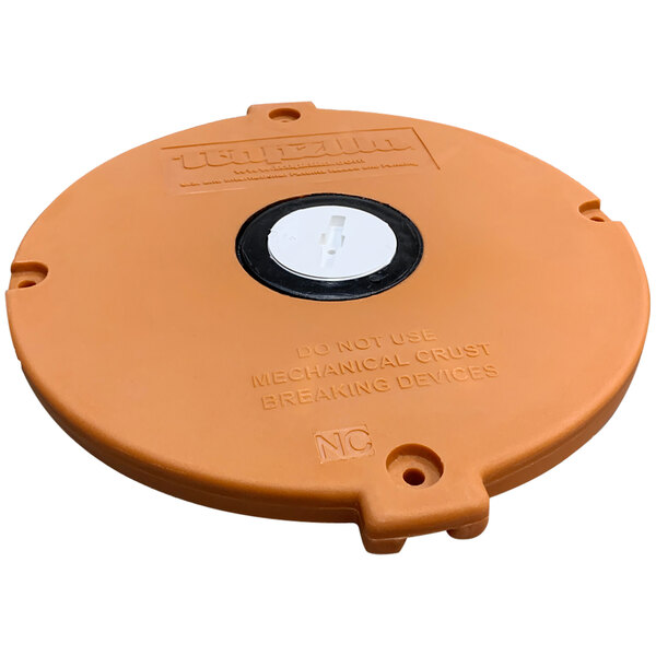 An orange round cover for a Thermaco Trapzilla with a white circle and black button.