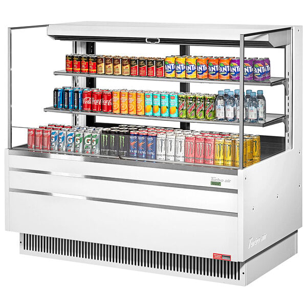 A white Turbo Air horizontal refrigerated curtain merchandiser with drinks and cans on shelves.