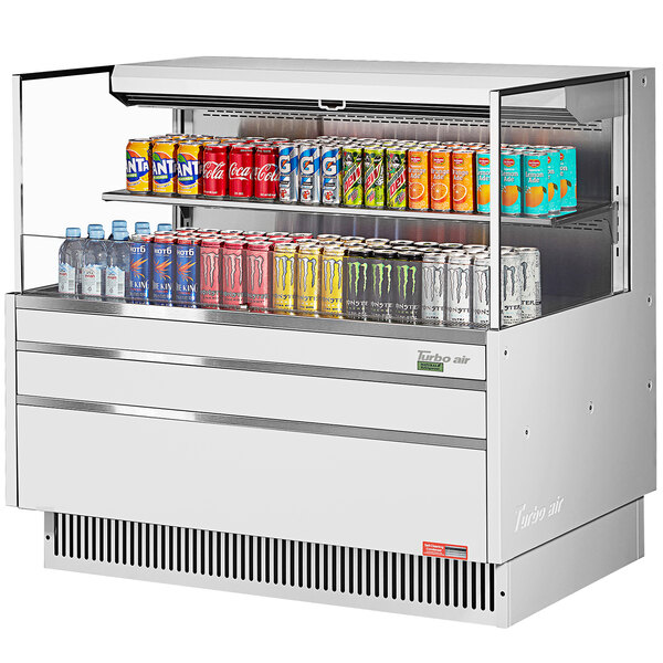 A white Turbo Air refrigerated curtain merchandiser with drinks on it.