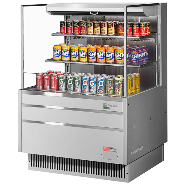 A Turbo Air stainless steel horizontal refrigerated curtain merchandiser filled with cans of beer.