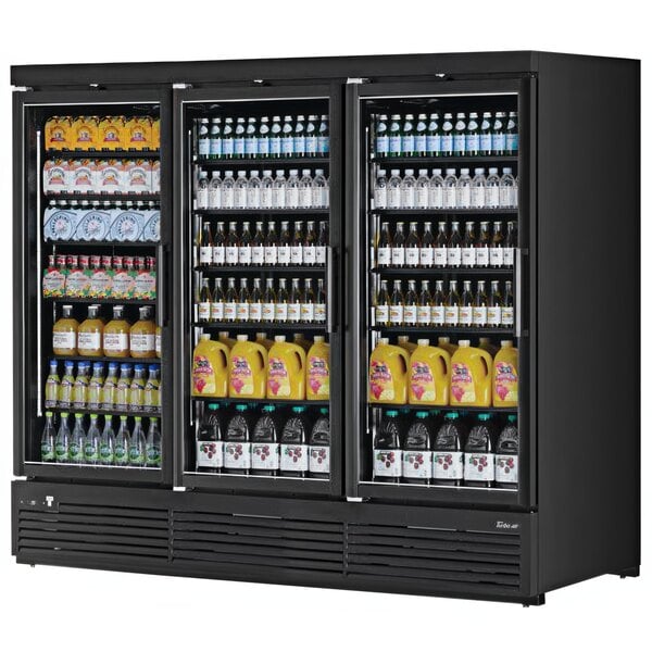 A black Turbo Air refrigerated glass door merchandiser full of bottles of liquid and juice.