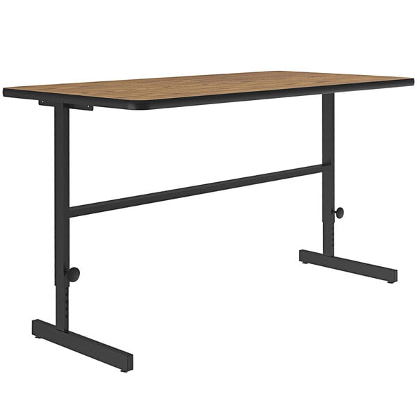 A Correll medium oak table with a black metal frame.
