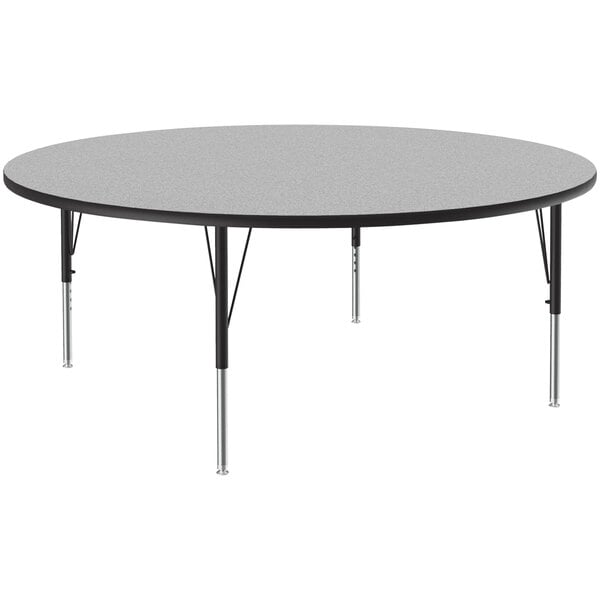 A Correll round activity table with a gray granite top and black metal legs.