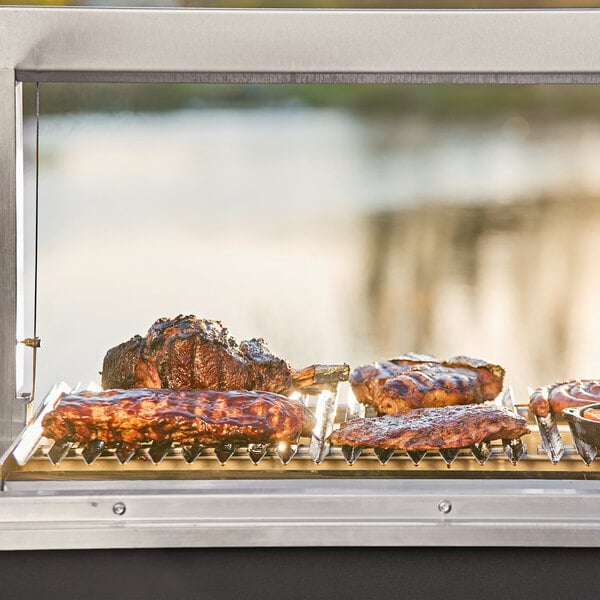 A Nuke BBQ Puma grill with meat cooking on it.