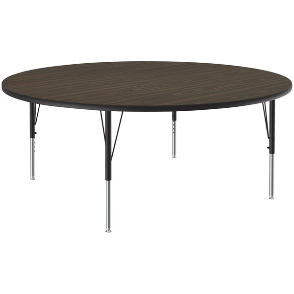A Correll round activity table with black metal legs and a brown top.