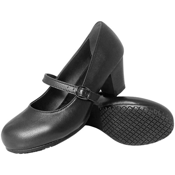 A pair of black dress shoes with a strap and buckle, featuring a low block heel and textured non-slip soles.