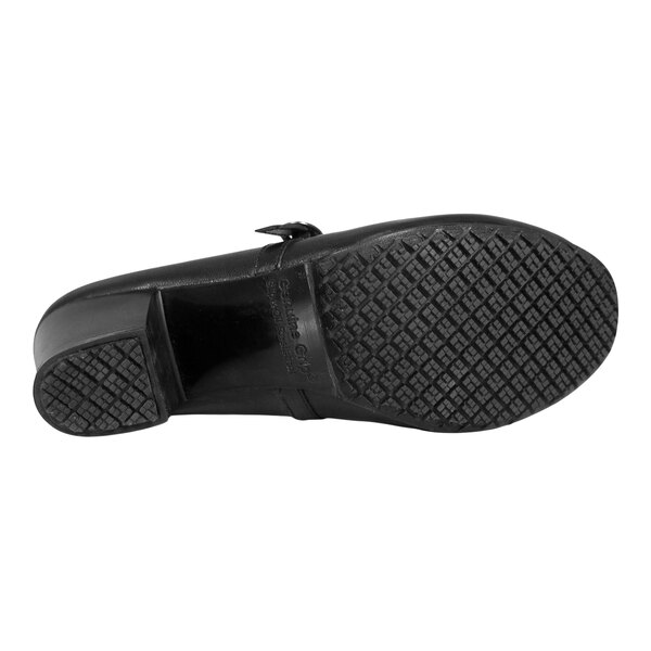 The image shows the bottom view of a black shoe with a textured, non-slip rubber sole and a low heel.
