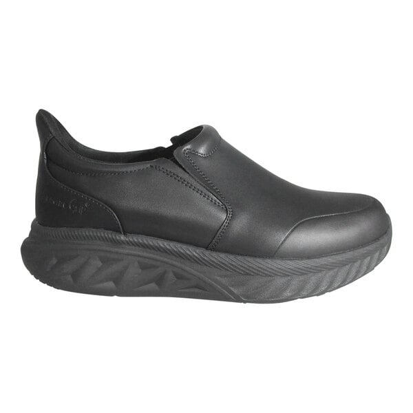A black slip-on shoe with a thick, textured sole and smooth upper material.