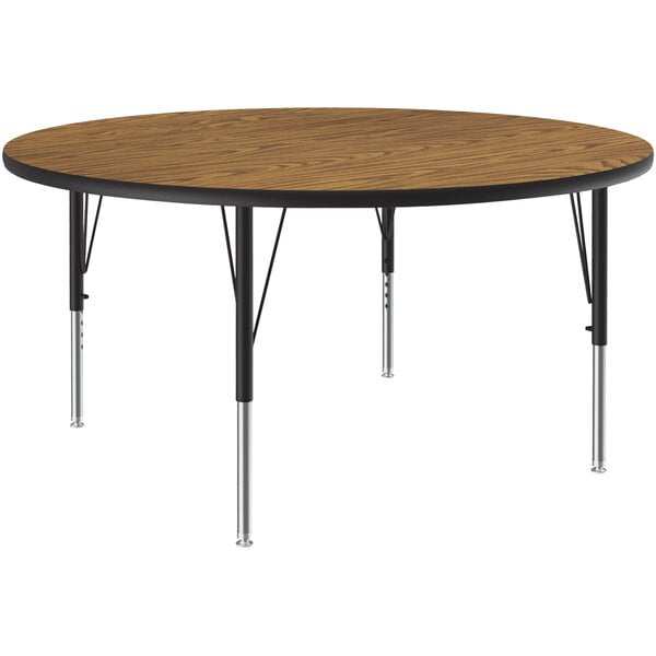 A Correll round activity table with metal legs and a medium oak top.