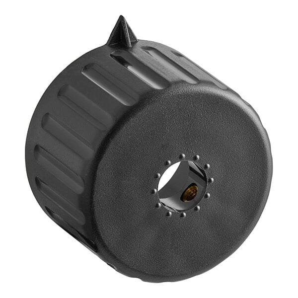A black plastic cylinder with a pointy hole in the top.