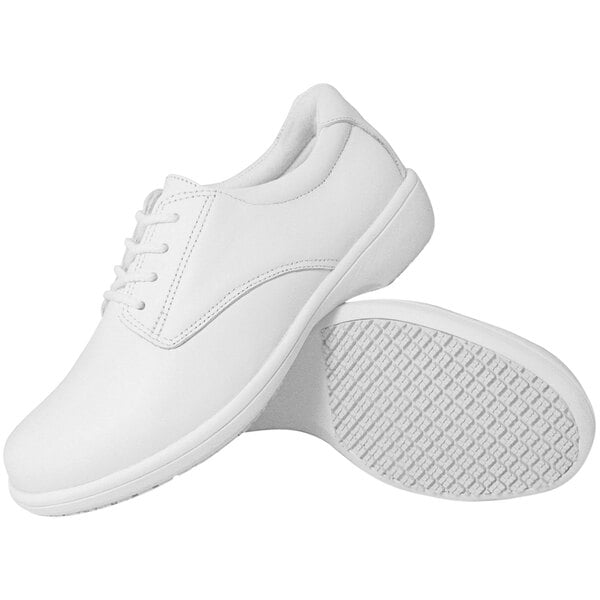 A pair of plain white lace-up shoes with textured non-slip soles, shown from the side and bottom views.