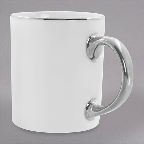 A white 10 Strawberry Street porcelain mug with a silver C-handle.