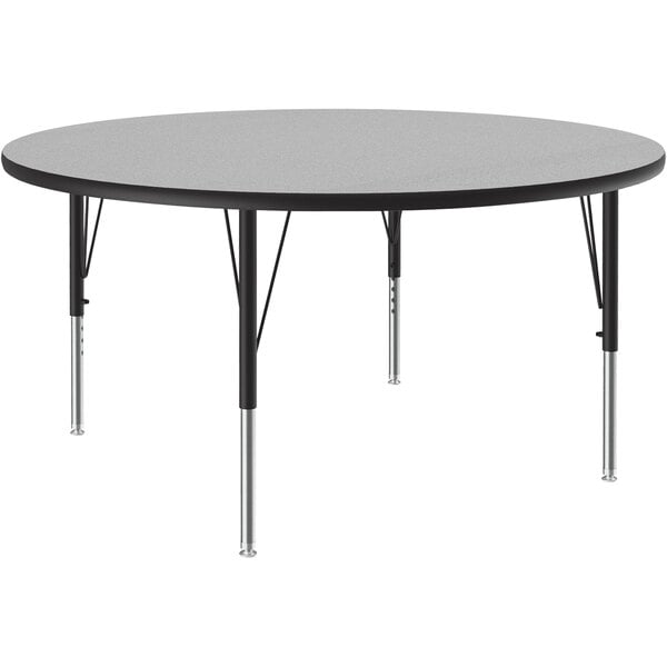 A Correll round activity table with metal legs and a gray granite top.