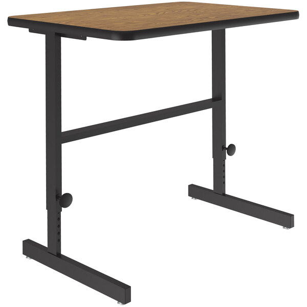 A Correll medium oak computer desk with black metal legs.