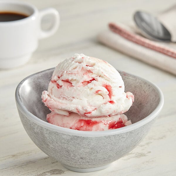 A bowl of red and white ice cream with Oringer Red Raspberry Variegate on top.