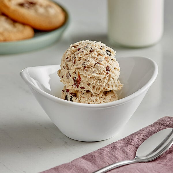 A bowl of Oringer rum raisin hard serve ice cream with a spoon.